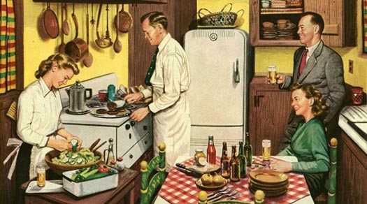 Man preparing dinner, while his wife makes the salad